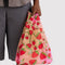 model holding colorful baby baggu with all over strawberry blossom print