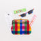 novelty bookmark set with green lip balm, rainbow gingham sunglasses and pouch, strawberry gum, and a receipt for a cat cafe