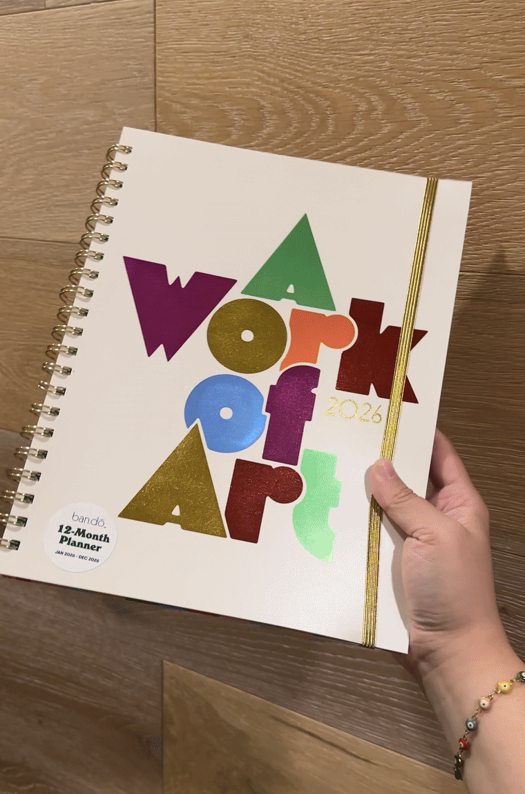 Gif showing the A Work of Art planner cover being rotated, so that the metallic letters shift colors.