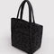 side view of dark grey cloud bag with black ditsy floral print