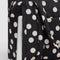 black cloud carry-on bag with white polka dot print with a laptop inside