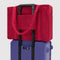 cherry red cloud carry on bag on a suitcase