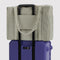sage and white vertical stripe cloud carry on bag on a suitcase