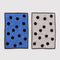 flattened set of two polka dot hand towels: blue with black dots, and cream with black polka dots