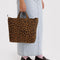 model holding brown leopard horizontal zip duck bag