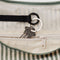 black interior key leash of pale sage and white vertical stripe large crescent bag
