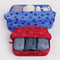 set of 2 large packing cubes with red and bright red dots and blue with navy polka dots with items inside