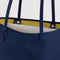 up close of reversible navy tote with yellow interior