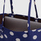 interior of medium reversible tote with navy and white polka dot and brown interior