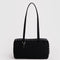 black nylon bowler bag with silver studs on the side