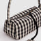 up close of key leash of black and cream gingham nylon loaf bag
