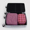 set of two packing cubes: pink plaid and pink houndstooth in a suitcase