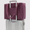 wild plum small cloud carry-on bag on a suitcase