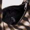 interior pocket of brown blurred gingham small meringue bag with thick twist strap