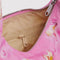 interior pocket of bright pink small meringue bag with gold melting star print and thick twist strap