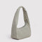 sideview of green and white vertical stripe small meringue bag with thick twist strap