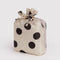 packaged set of three standard baggus: cream with black polka dots, blue polka dot, and red polka dot
