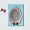 front of mini photo album with blue and lavender frame and black with blue micro polka dots inside