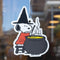snoopy witch stirring a potion air freshener hanging in front of a window