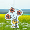 woodstock holding orange flower air freshener on an outdoor background