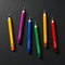 scattered colorful pencil taper candle set of 5 in: purple, blue, green, yellow and red