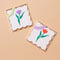 packaged set of 8 letterpress coasters with  red tulip and purple tulip print