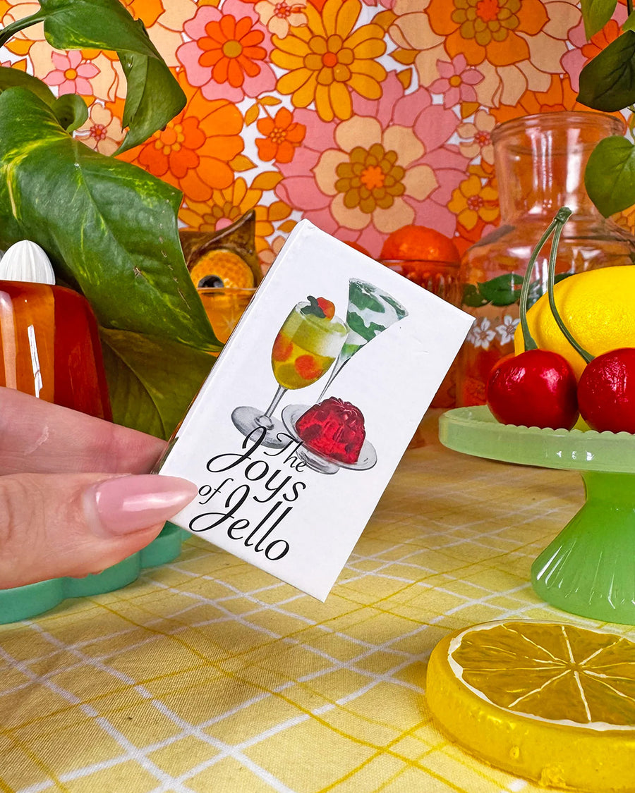 model holding 'joys of jello' cookbook matchbook