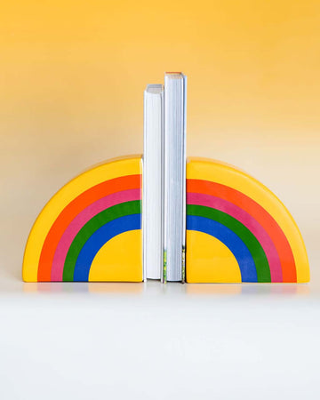 ceramic rainbow shaped bookends with books in the center