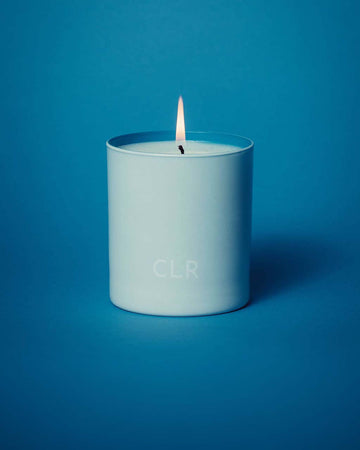 lit white candle with blue interior