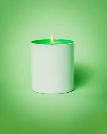 lit white candle with green interior