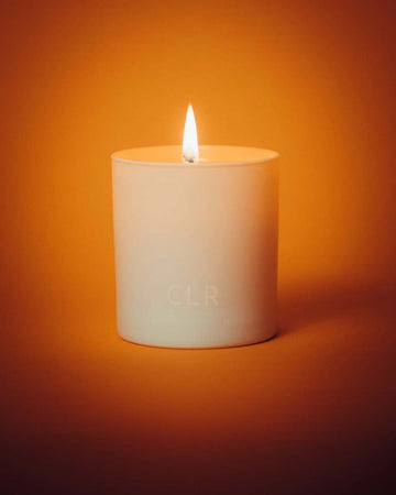 lit white candle with orange interior