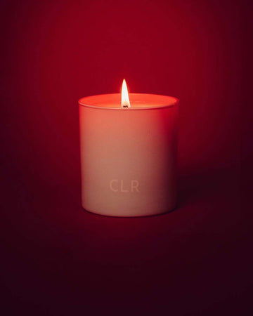 lit white candle with red interior