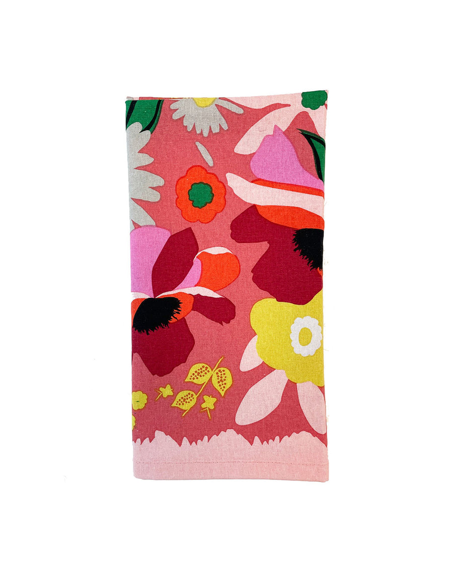 folded pink napkin with colorful abstract floral print