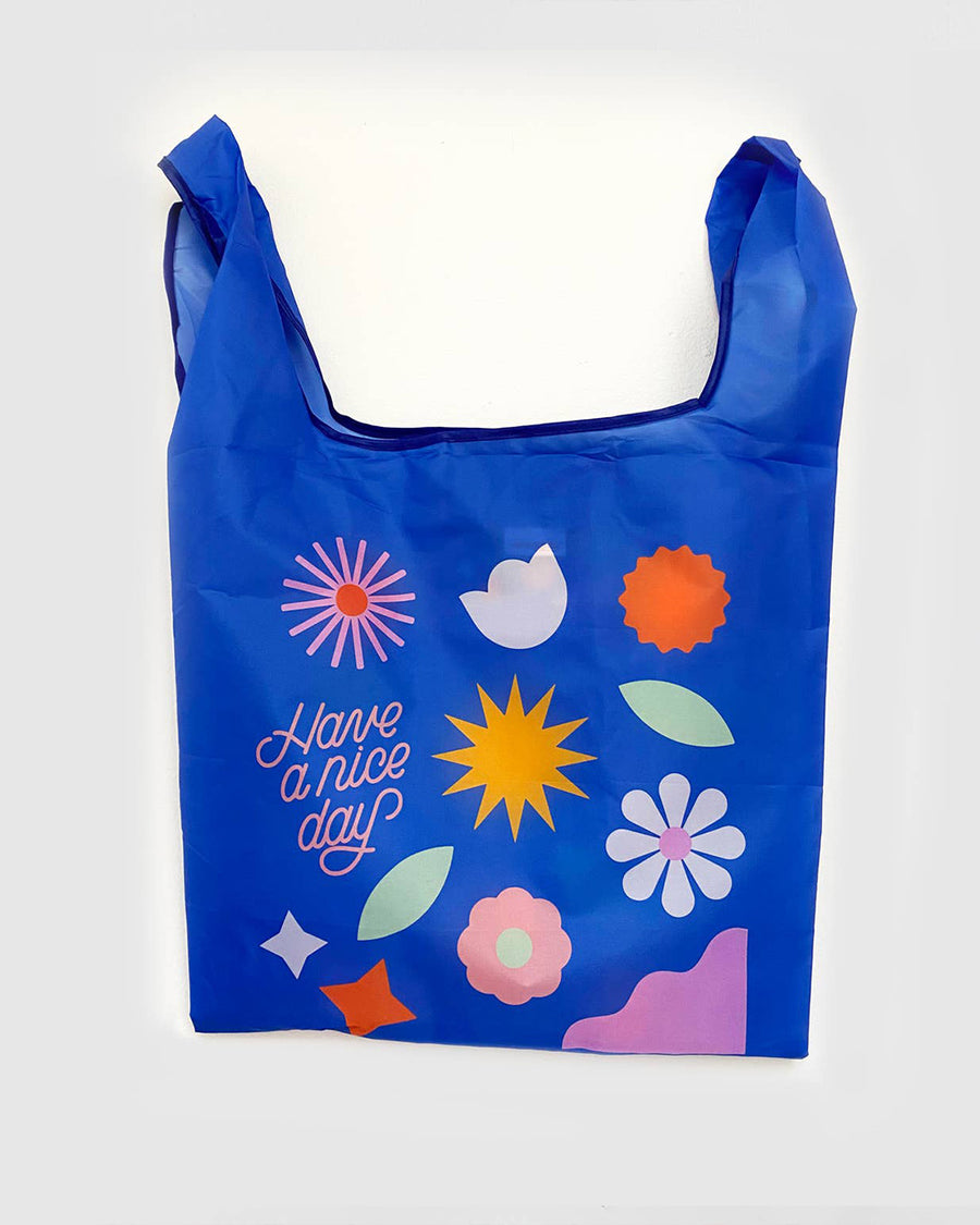 royal blue reusable bag with abstract floral print and 'have a nice day' on the front