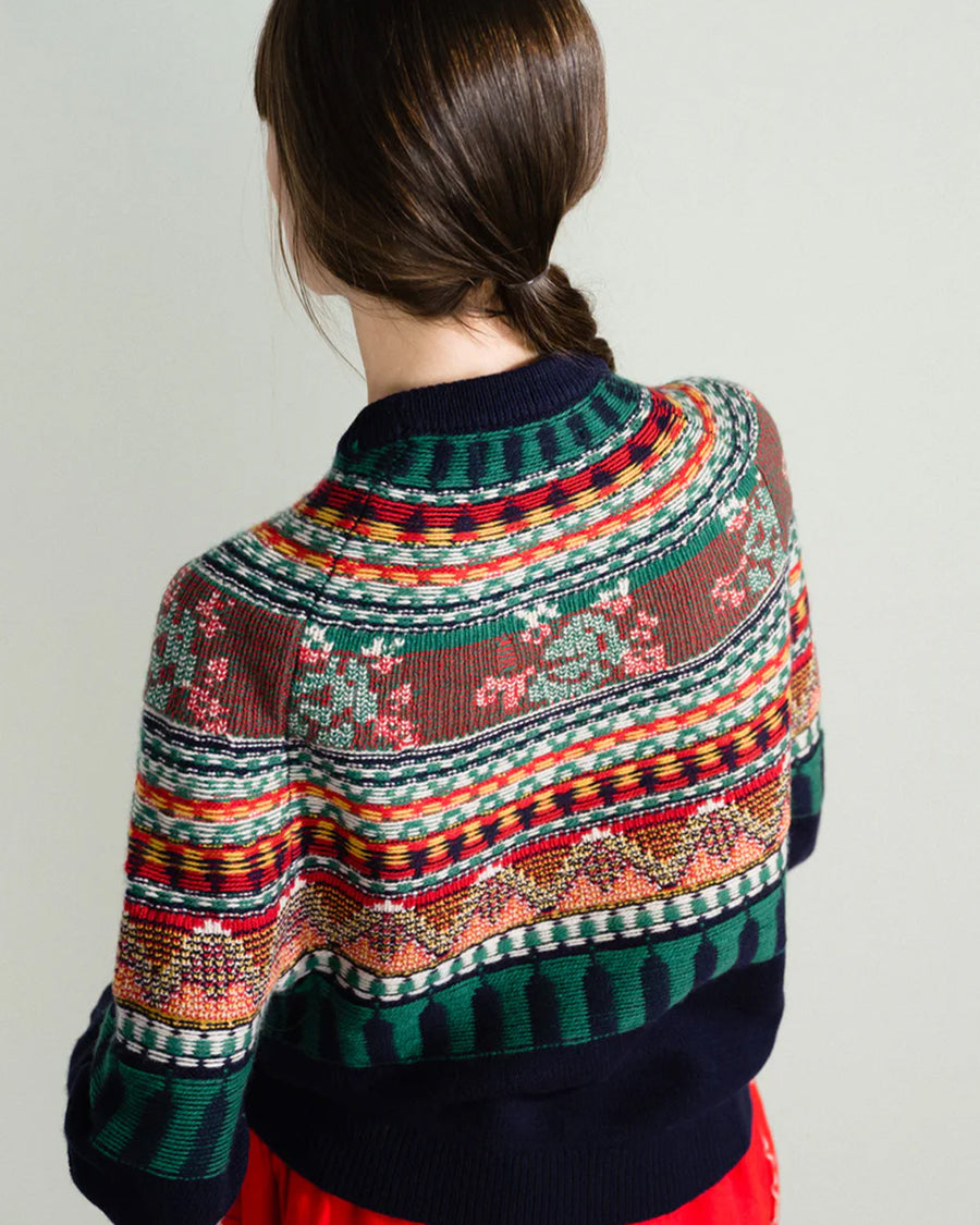 back view of model wearing navy sweater with colorful fair isle print on the top half