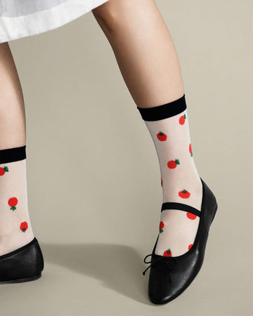 model wearing sheer socks with black top and dainty tomato print