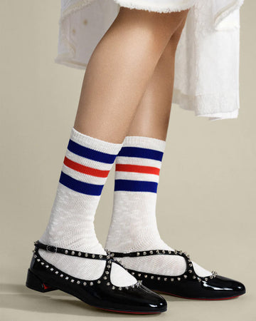 model wearing white socks with blue and red stripe top