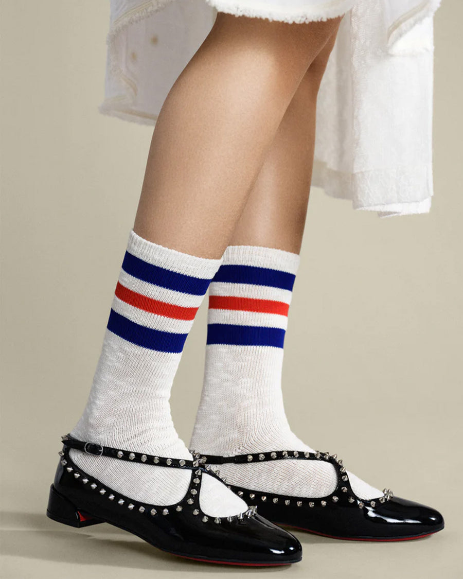 model wearing white socks with blue and red stripe top