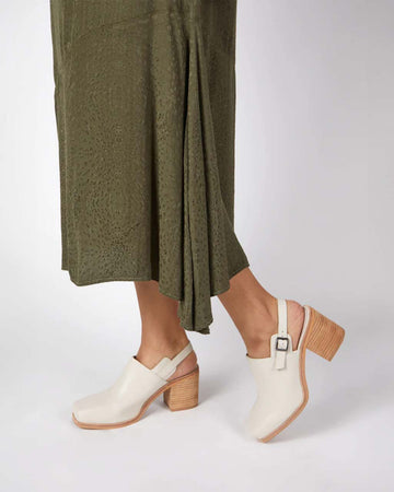 model wearing cream heeled mule with chunky heel