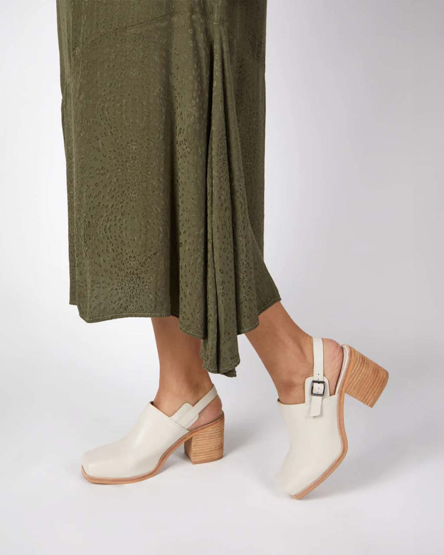 model wearing cream heeled mule with chunky heel