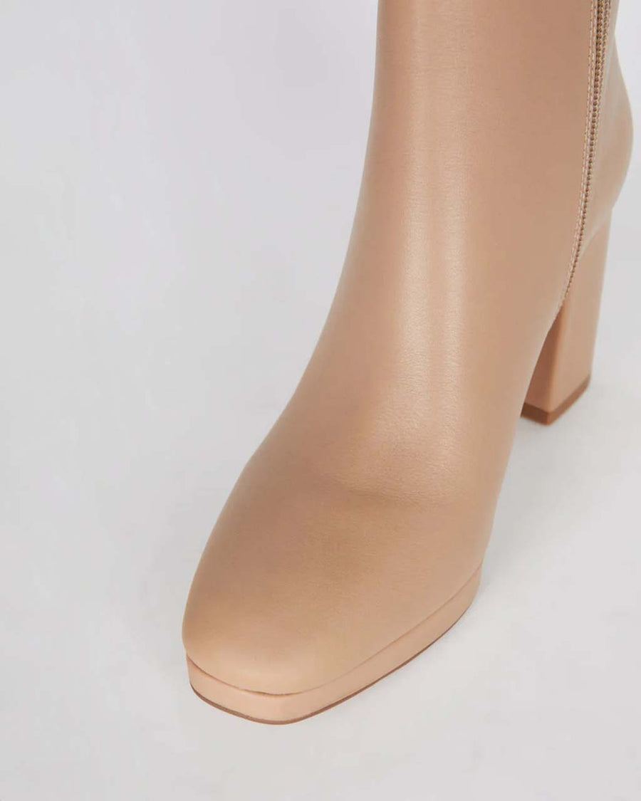 up close of tan heeled side zip boots