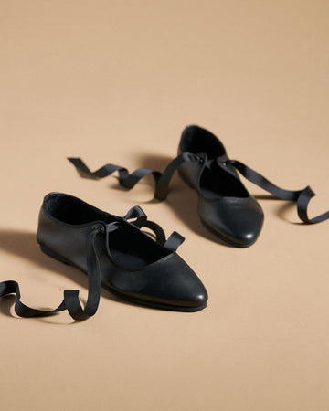 black ballet inspired flats with tie laces and pointed toe