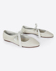 sideview of cream ballet shoes inspired flat with pointed toe and tie