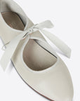 up close of cream ballet shoes inspired flat with pointed toe and tie