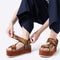 model wearing yellow, orange and brown print platform sandals with chunky chestnut sole