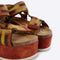up close of yellow, orange and brown print platform sandals with chunky chestnut sole