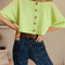 back view of model wearing  lime green button back crop top