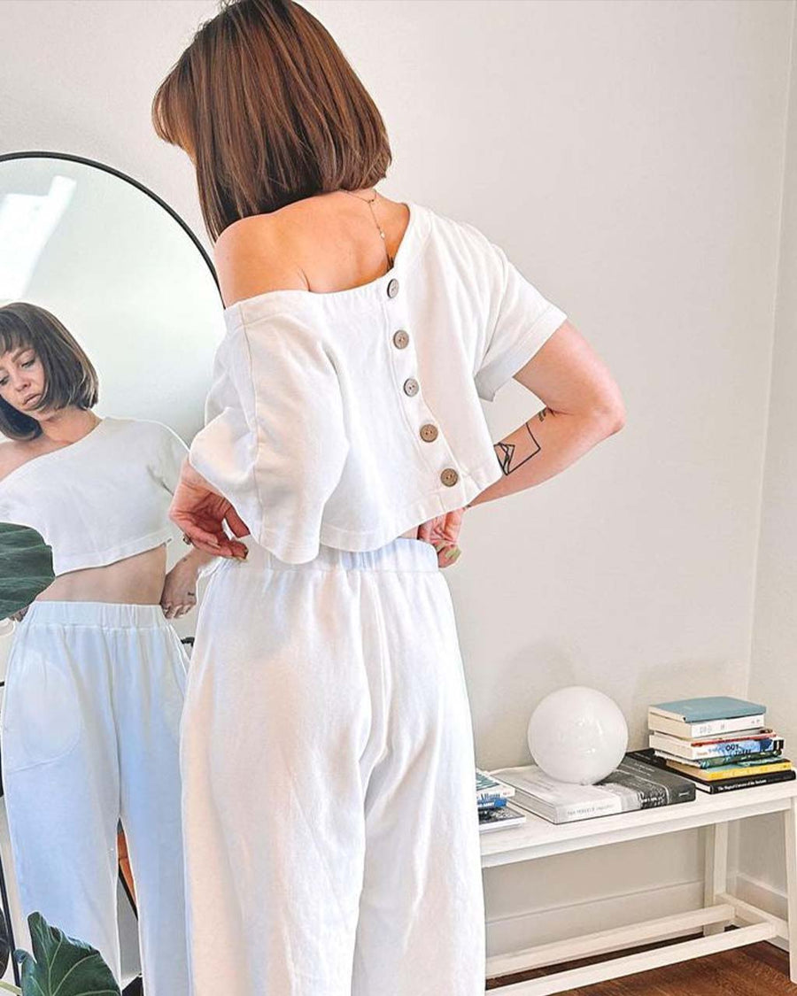 back view of model wearing white short sleeve crop top with matching wide leg pants