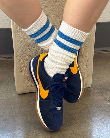 model wearing white crew socks with double light blue stripes at the top