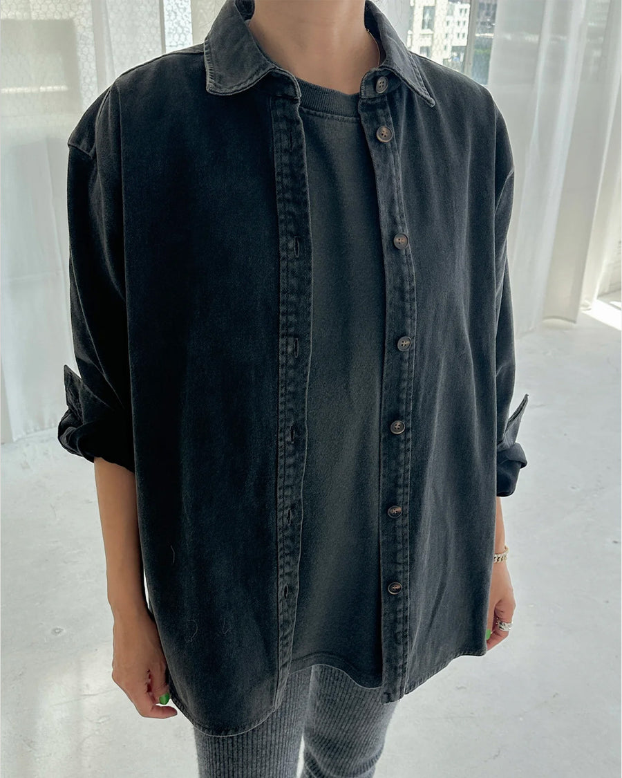 model wearing oversized washed black button down jacket